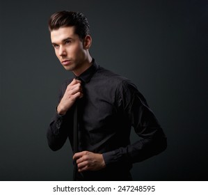 Close Up Portrait Of A Cool Young Man In Black Shirt And Tie