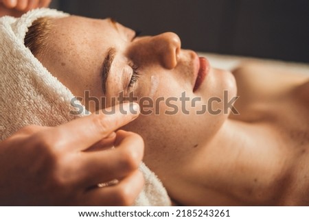 Close up portrait of cosmetologist make rejuvenating face procedures for woman client in spa salon. Beauty treatment. Aesthetic cosmetology, face care. Facial