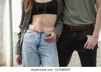 Close up portrait of couple men and woman with fashion leather belts and jeans. Casual urban style. Clothing and accessories for a man and a woman. - Shutterstock ID 2179389207