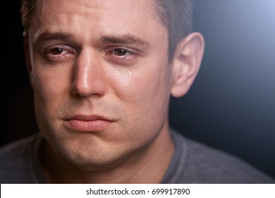 Close Up Portrait Of Crying Young White Man Looking Away