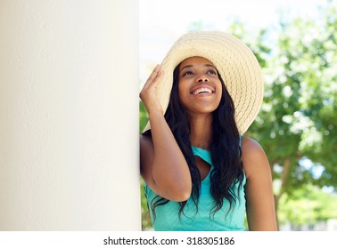 Close up portrait of a cute african american woman smiling with sun hat - Powered by Shutterstock