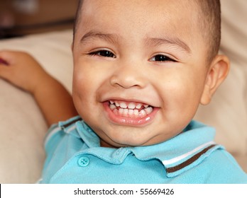 Close Up Portrait Of Cute Little Baby Boy Aged 2 With Big Toothy Smile.