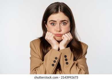 Close up portrait of cute and silly, coy woman, looking tender at camera, standing over white background - Shutterstock ID 2143992673