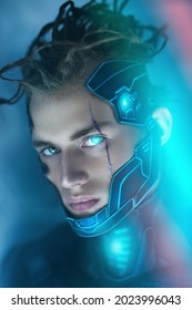 Close up portrait of a cyberpunk warrior wearing a mask and with scar on his face in neon night light. World of the future. Game, virtual reality. Cyberpunk concept.