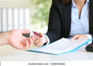 Close up portrait of a dealer hand giving a pen to a client to sign a contract