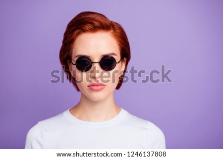Close up portrait of deeply thinking charming she her girl in black eyeglasses with short hairdo weared in white casual pullover outfit on violet background