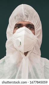 Close Up Portrait Of Doctor Or Epidemiologist With Protective Suite And Medical N95 Face Mask Looking At Camera - Concept Of Doctors At Coronavirus Or Covid 19 Screening Process.