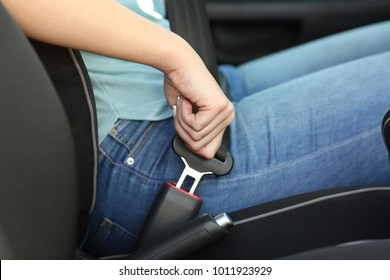 Close up portrait of a driver hand fastening seatbelt in a car