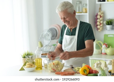 Close up portrait of elderly making salad at kitchen - Powered by Shutterstock