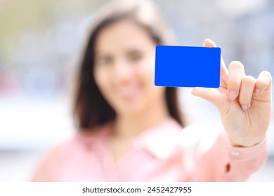 Close up portrait of an elegant woman hand showing black credit card mock up in the street - Powered by Shutterstock