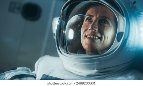 Close Up Of Portrait of an Excited Happy Woman Astronaut Wearing a Helmet and Space Suit, Looking at Earth From Outer Space Region. Sci-Fi Cosmos Expedition, Discovery and Exploration of the Universe - Powered by Shutterstock