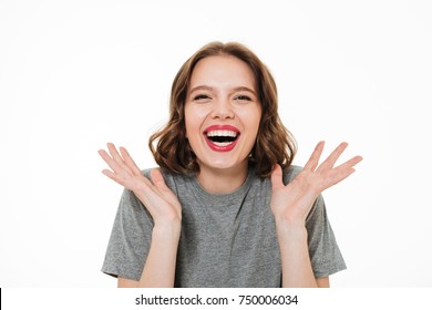 Close Up Portrait Of An Excited Smiling Woman With Make-up Laughing At Camera And Gesturing With Hands Isolated Over White Background