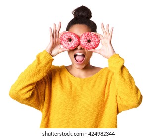 Close Up Portrait Of Excited Young African Woman Covering Her Eyes With Donuts On White Background