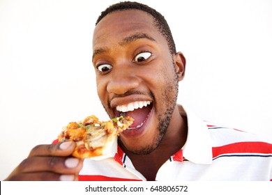 Close Up Portrait Of Excited Young African Man Eating Pizza