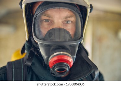 Close up portrait of face of firefighter posing at the photo camera