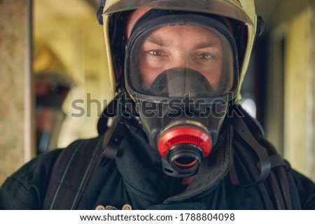 Close up portrait of face firefighter wearing protective uniform and an protective mask