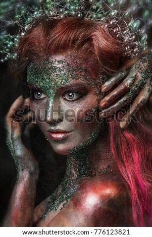 close up portrait of fantastic colorful young girl. professional creative  makeup with beads on face. paint on face