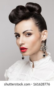 Close Up Portrait Of Fashionable Brunette Model. Updo, Vintage Accessories. Makeup And Hairstyle. Red Lips, Large Earrings