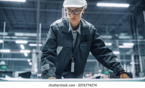 Close Up Portrait Of Female Engineer Looking At A Technical Blueprint At Work In An Office At Car Assembly Plant. Industrial Specialist Working On Vehicle Parts In Technological Development Facility.