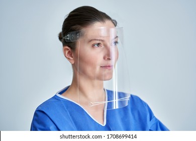 Close Up Portrait Of Female Medical Doctor Or Nurse Wearing Face Shield