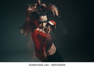 Close portrait of a female mixed martial arts fighter with a bandage on her hands. Long exposure shot