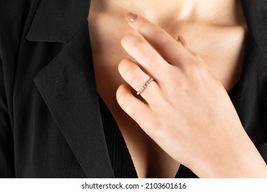 Close portrait of female model in gold and silver rings. Isolated on white background . Diamond jewelry. Diamond ring in women's hands
