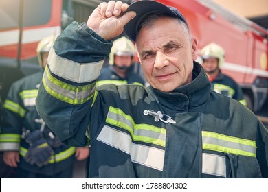 Close up portrait of firefighter wearing protective fireproof uniform standing at the outdoors - Powered by Shutterstock