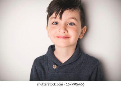 A Close Portrait Of A Five Years Old Boy Over White