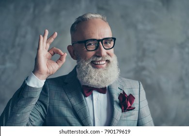 Close up portrait of funny excited cheerful with groomed stylish moustache hipster grandfather sharp-dressed checkered jacket burgundy tissue in pocket making ok symbol isolated on grey background