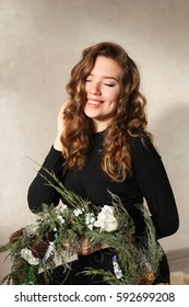 Close Portrait Of Girl With Beautiful Smile With Dimples And Curls On Blond Hair. Woman Holds Wreath Or Floral Arrangement. Concept Of Happiness, Carefree, Beauty, And Shampoo Ads, Solar Fun-filled