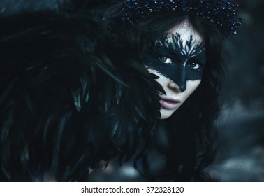 close portrait of a girl with the wings of a crow, dark angel, birds and razresovannym face