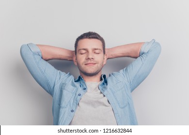 Close Up Portrait Of Good-wearing Attractive Gentleman With Calm Face Close Eyes Stand Isolated On Light Gray Background With Hands Above Head