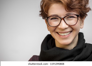 Close up portrait of gorgeous sensual woman with perfect clean skin, wearing short haircut with curly ginger hair smiling at camera keeping lips slightly parted.