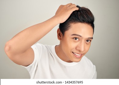 Close Up Portrait Of  Handsome Asian Man Touching His Perfect Hair