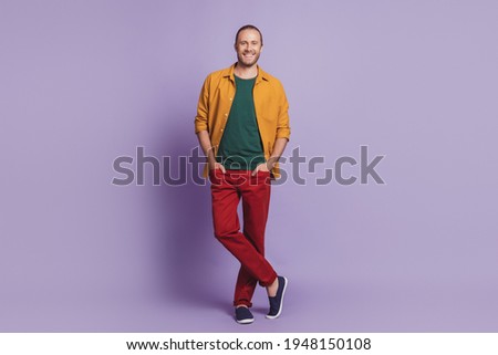 Close up portrait of handsome business man guy posing hands pockets on purple wall