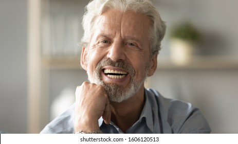 Close Up Portrait Handsome Face Of 60s Elderly Man Having Candid Wide Toothy Smile Put Fist Under Chin Looking At Camera Concept Of Healthy Person Enjoy Retired Life, Dentures Services For Old People