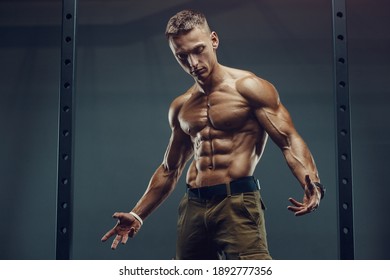 Close up portrait of a handsome fitness man in white shirt in gym. Muscles workout fitness and bodybuilding concept background