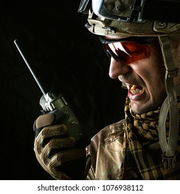 Close Up Portrait Of Handsome Military Man. Macro Shot On Black Background With Portable Radio Transceiver