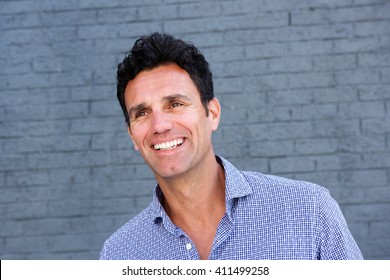Close Up Portrait Of A Handsome Older Man Smiling Against White Background