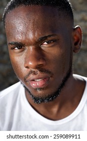 Close Up Portrait Of A Handsome Young Black Man With Sweat Dripping Down Face