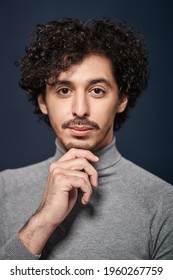 Close Up Portrait Of A Handsome Young Man With Curly Dark Hair On A Black Background. Men's Beauty.