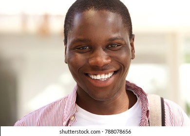 Close up portrait of happy black college student smiling outside - Shutterstock ID 788078656