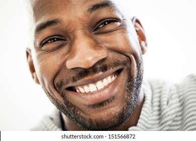 Close up portrait of a happy black man in his 20s isolated on a white background
