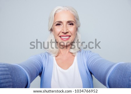 Close up portrait of happy cheerful excited delightful with toothy beaming smile granny grandmother grandma having a video call via internet, isolated on gray background