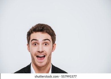 Close up portrait of a happy cheerful man peeking out from the edge isolated on a white background