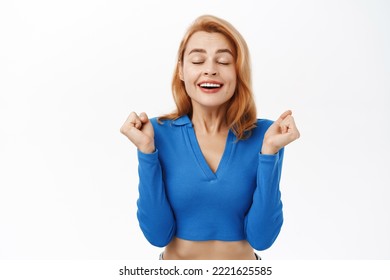 Close Up Portrait Of Happy Girl Rejoicing, Dancing And Triumphing, Feeling Ecstatic, Celebrating, She Has Relieved Joyful Face Expression, Stands Over White Background