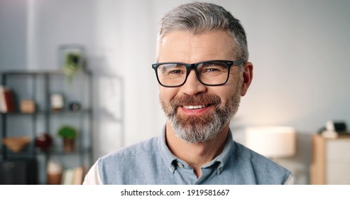 Close up portrait of happy joyful handsome middle-aged senior Caucasian man in eyeglasses looking at camera and smiling in good mood at home, positive emotions, cheerful face expression - Powered by Shutterstock