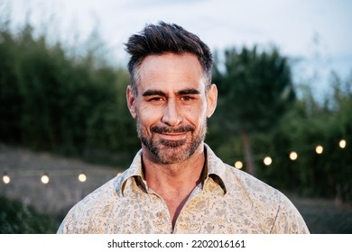 Close Up Portrait Of Happy Mature Adult Man Looking And Smiling At Camera Standing Outdoors. High Quality Photo