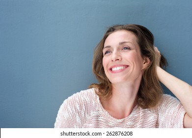 Close Up Portrait Of A Happy Older Woman Laughing With Hand In Hair