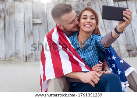 Close up portrait of happy smiling couple using phone. Young couple with phone taking photo.